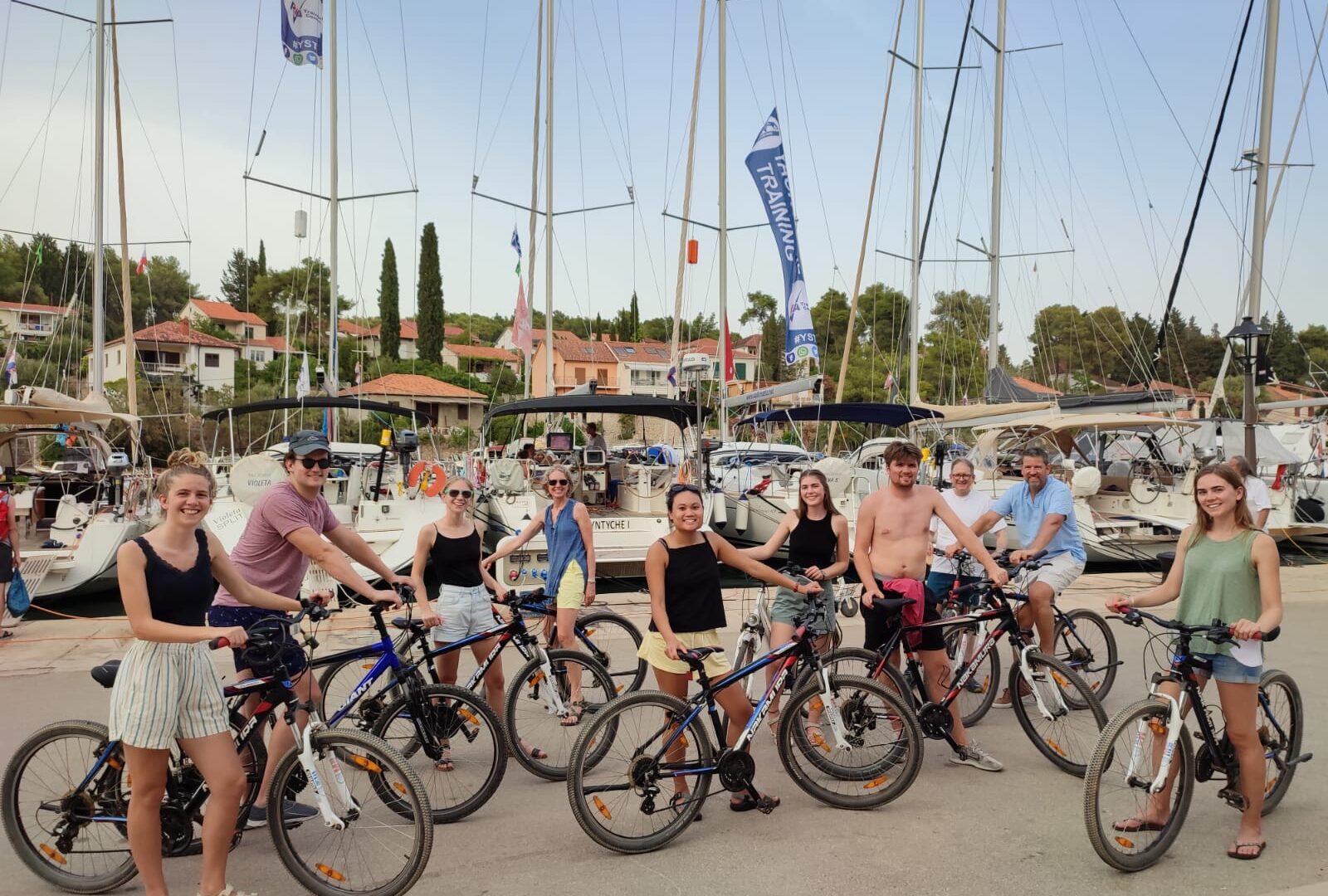 A realistic image of people on bicycles in a marina.
