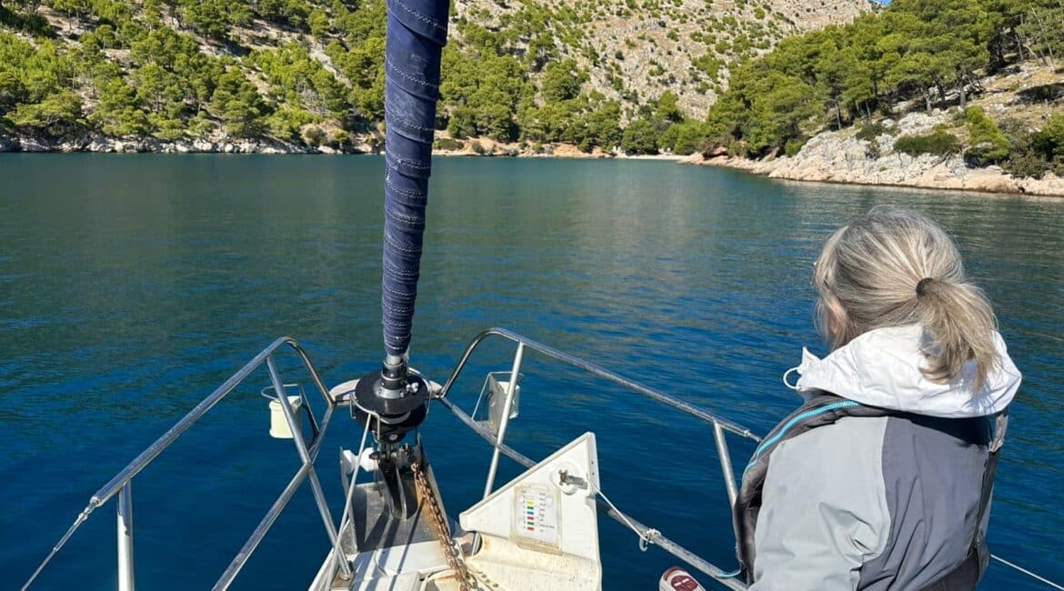 Two students practicing sail handling on a sailing boat during an RYA Competent Crew course.
