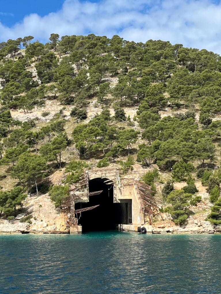 A sailing yacht anchored in a secluded turquoise cove on Brač island, highlighting the Brač hidden gems accessible only by sea.